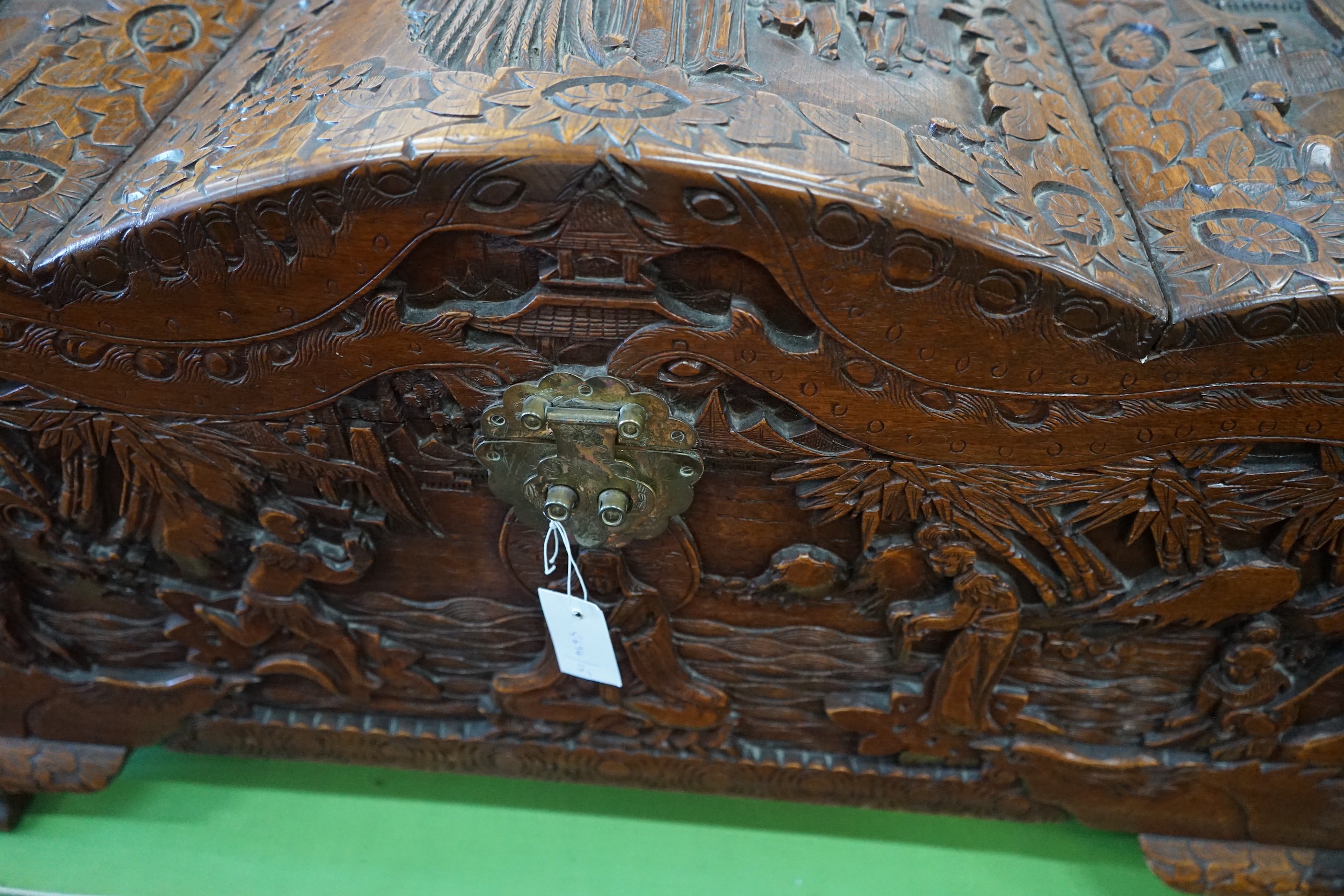 A Chinese carved camphorwood coffer with domed cover, length 93cm, depth 43cm, height 55cm